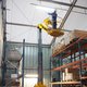 A Haulotte Star 10 10m Mast Lift in a warehouse.